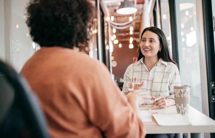 two people chatting at a cafe